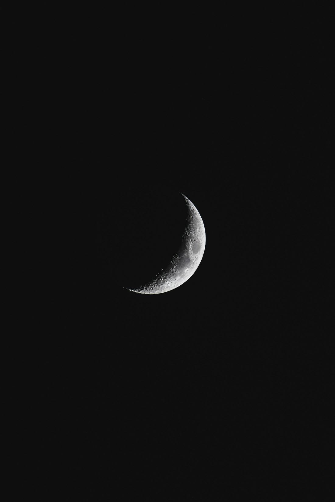 Close view of a crescent moon against a black sky