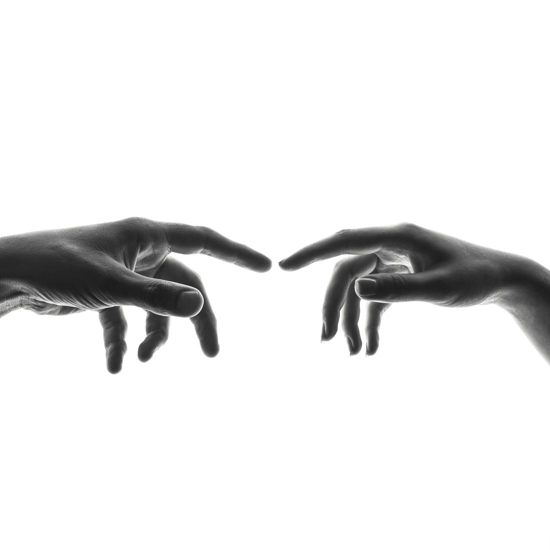 Two hands reaching toward each other